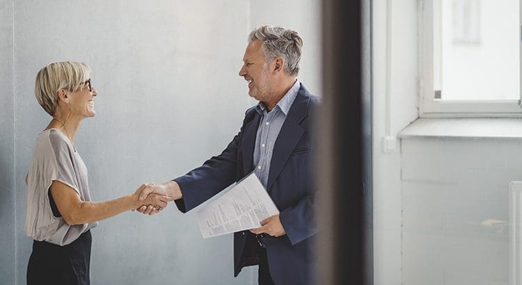 A man shaking hands with another person.