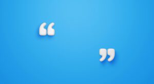 Two white paper cut outs of a quote on a blue background