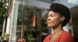 A woman with an afro looking out of the window.