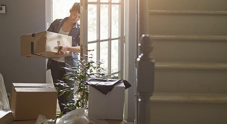 A woman is standing in front of the door.