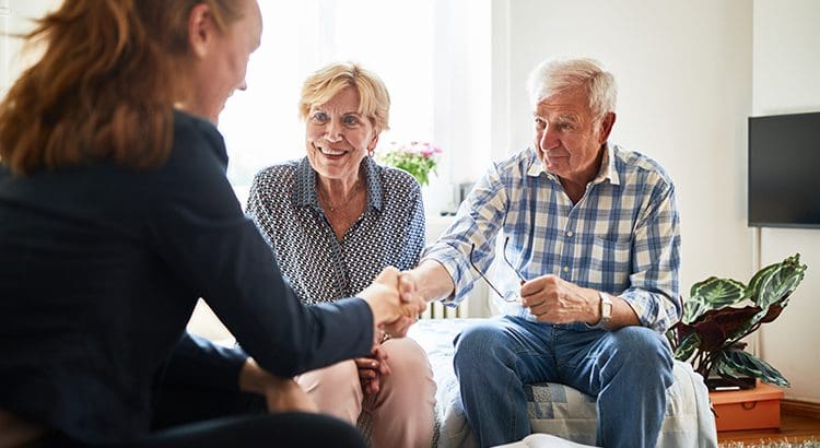 A group of people sitting around each other.