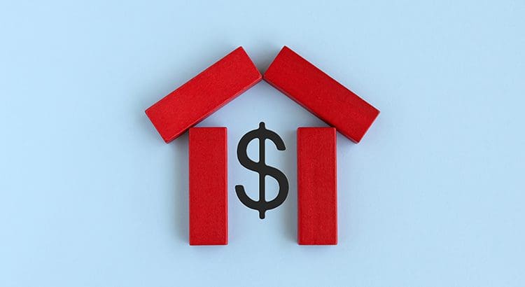A dollar sign sitting in front of two red blocks.
