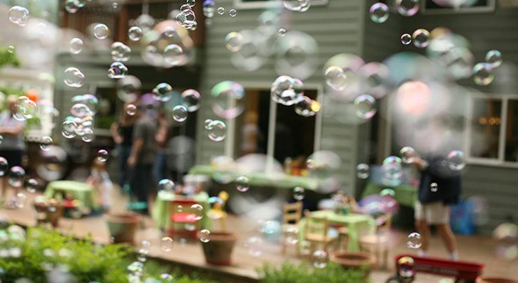 A bunch of bubbles are in the air outside