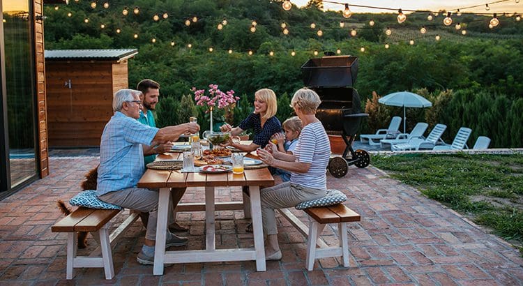 A group of people sitting at a table eating food.