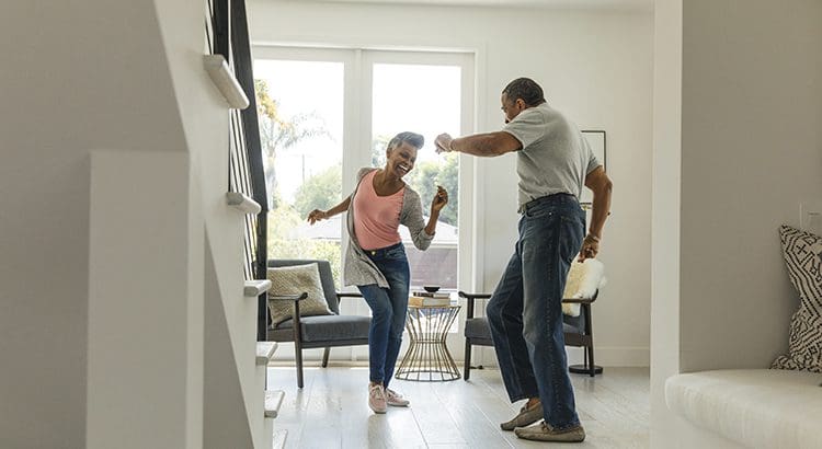 Two people playing wii in a living room.