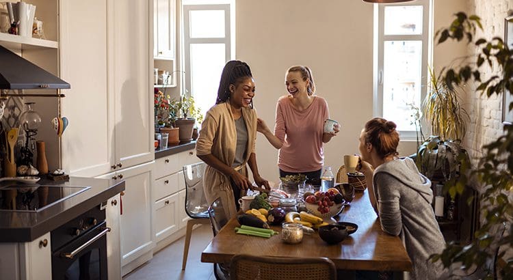A group of people standing around a table.