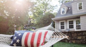 A hammock with an american flag pillow on it.