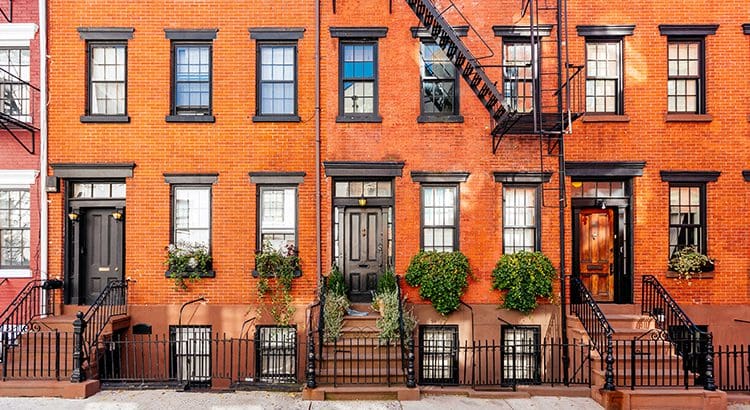 A red brick building with fire escape stairs.
