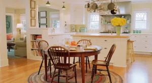 A kitchen with wooden chairs and a round table