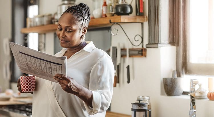 A woman holding an open calendar in her hands.