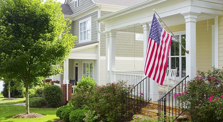 A flag is flying in front of the house.