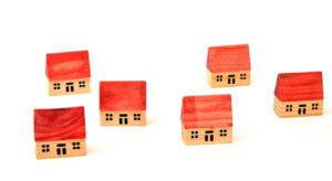 A group of wooden houses with red roofs.
