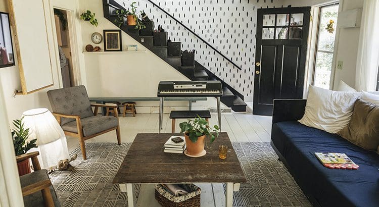 A living room with stairs and a coffee table