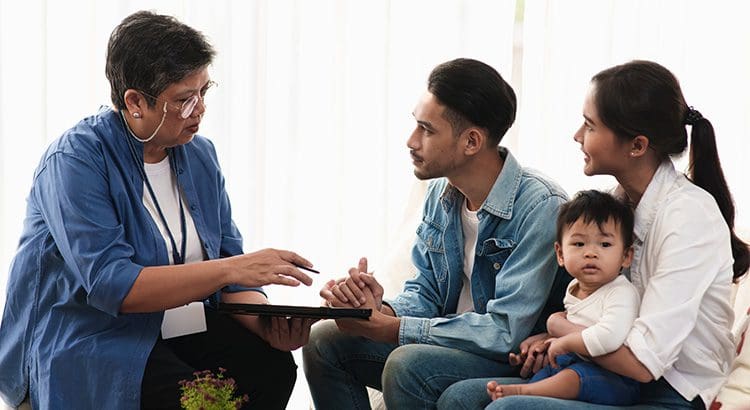 A group of people sitting around each other.