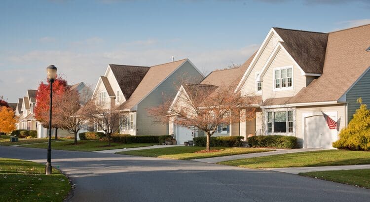 A row of houses on the side of a street.