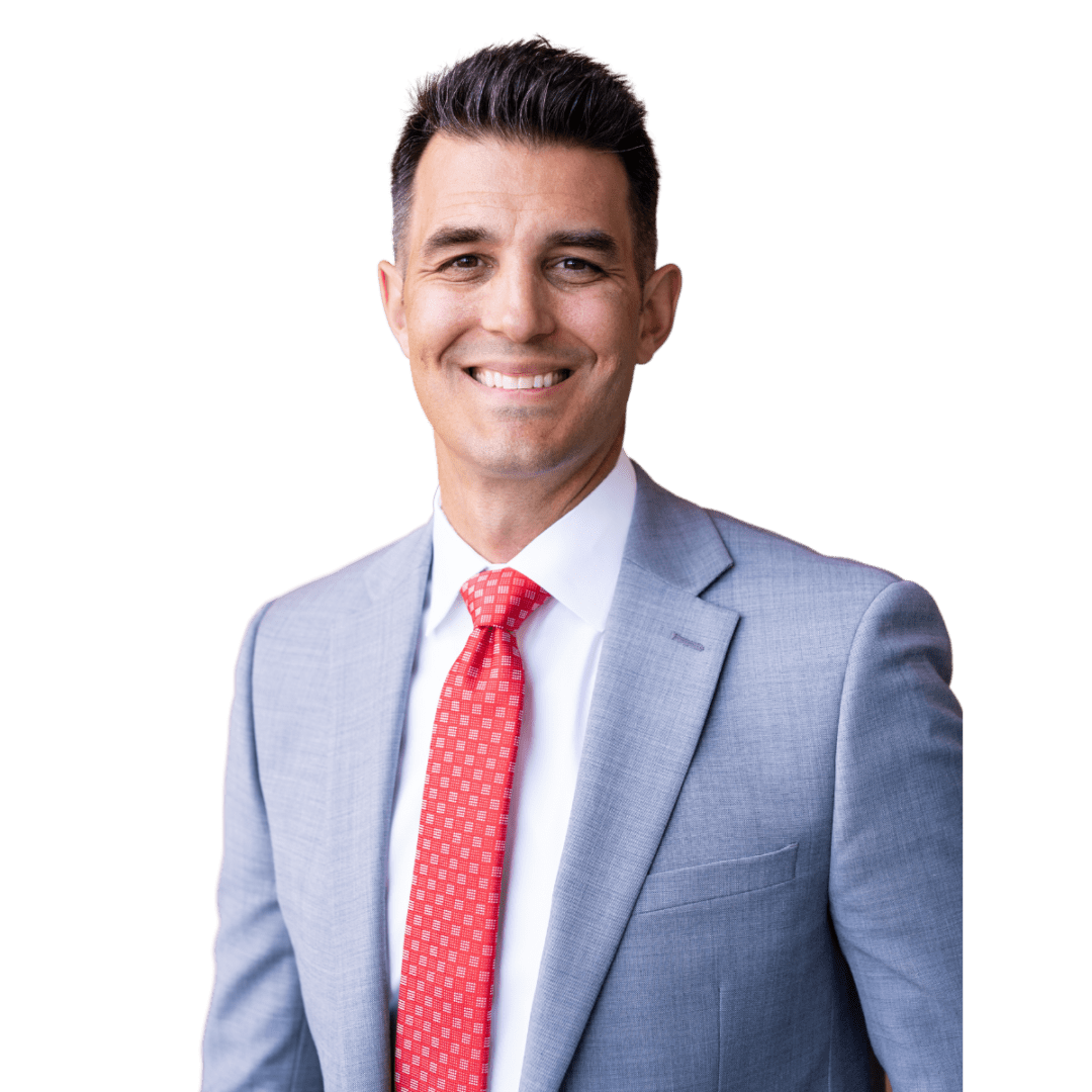 A man in a suit and tie smiling for the camera.