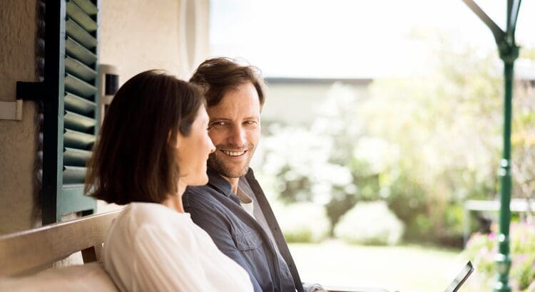 A man and woman smiling at each other.