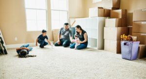 A family sitting on the floor in their new home