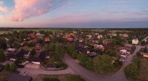 A bird 's eye view of houses and trees in the evening.