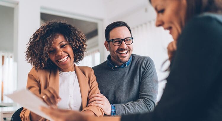 A group of people laughing together at an event.