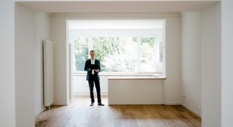 A man standing in front of an open window.