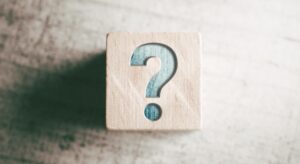 Wooden block with a question mark.