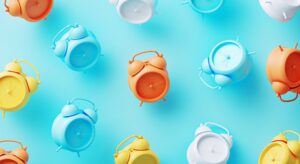 Colorful alarm clocks on a blue background.