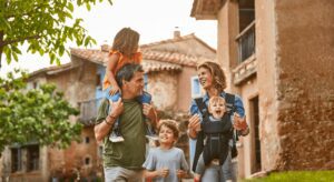 Happy family walking in rustic village setting.