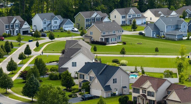 Suburban neighborhood with houses and green lawns.