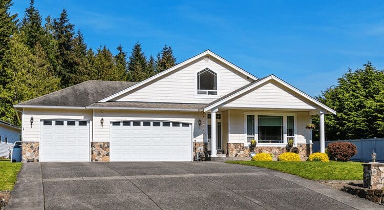 White suburban house with two-car garage.