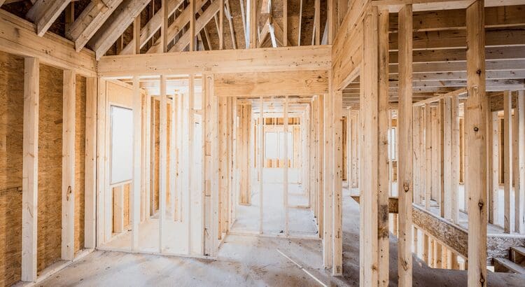 Wooden house frame under construction.