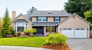Suburban house with well-maintained lawn and driveway.