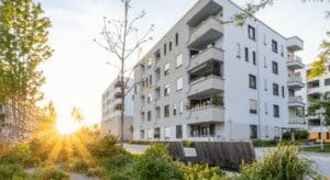 Modern apartment building with sunset background.