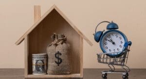 House model with money and clock.