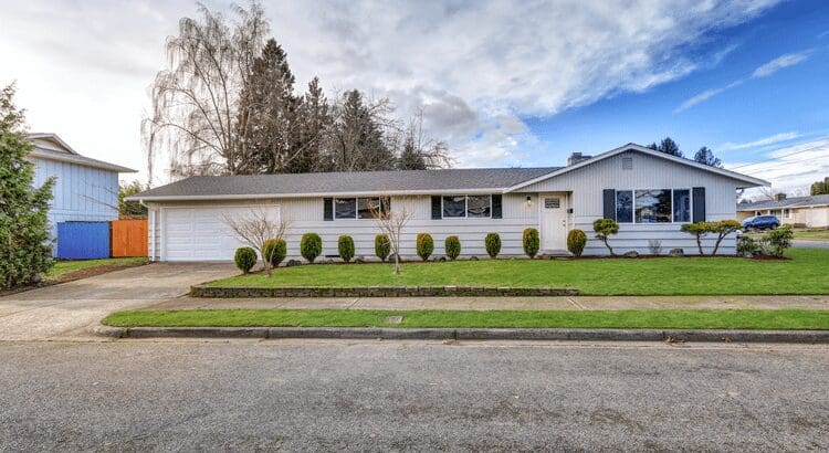 Single-story house with manicured front lawn.