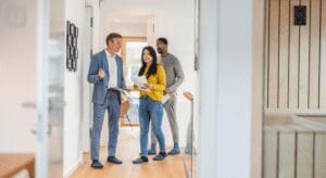 People walking in a modern office hallway.