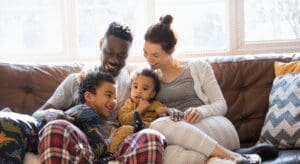 Happy family sitting together on a couch.