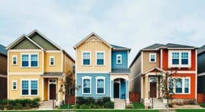 Three colorful suburban houses with front porches