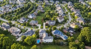 Aerial suburban neighborhood with houses and green lawns