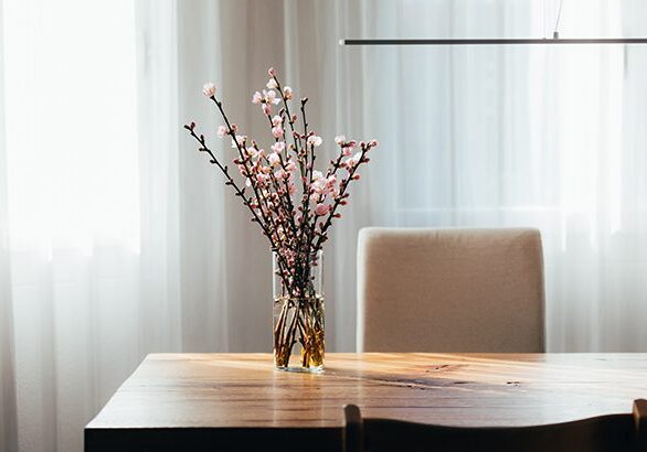 A vase with flowers on top of a table.