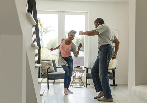 Mature couple dancing in living room