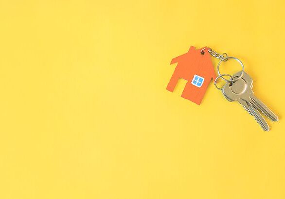 House and key on yellow background. Minimal creative style.