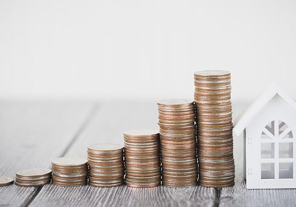 Money of coin stack step up growing growth with model white house on wooden table. Property investment and house mortgage financial concept, Home protect, Insurance. With copy space for your text.