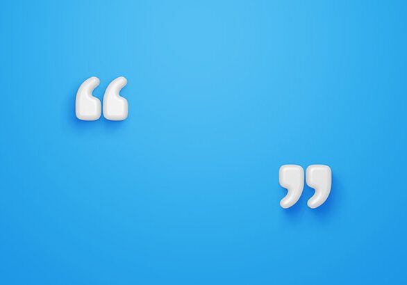 Two white paper cut outs of a quote on a blue background