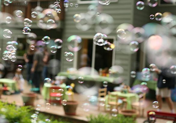 Bubbles floating in front of suburban house