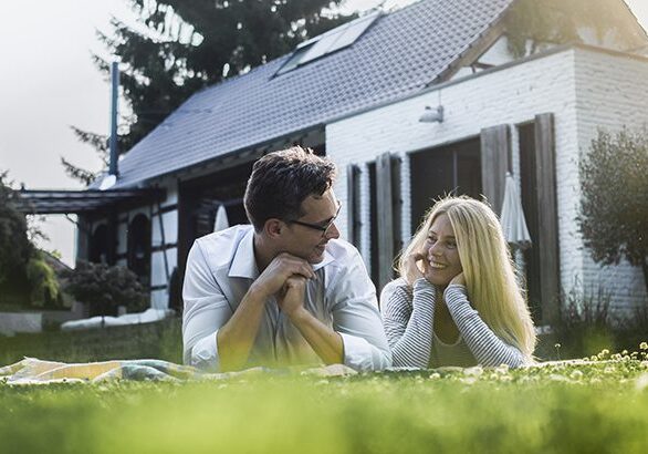 couple standing in front of her house, home, real estate, insurance, future, couple, in balance, family, love, stability, garden, sun, summer, Cologne, NRW, Germany